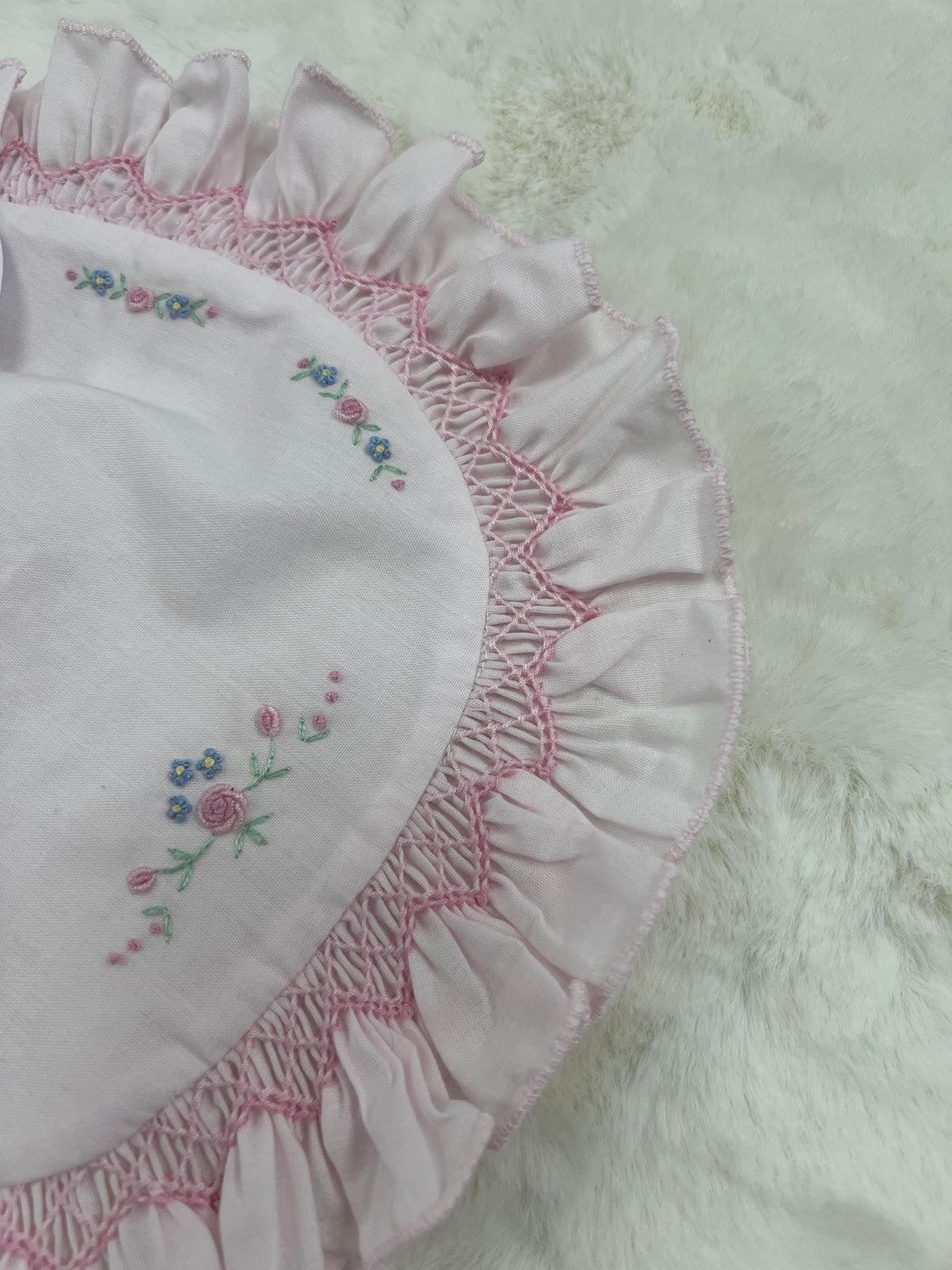 Pink smocked floral bib